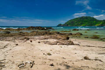 Wall Mural - Coral reefs at the edge of the sea against the blue sky.