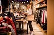 © BGStock72 - Young woman shopping and searching among clothes at clothes store