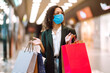 © maxbelchenko - Young woman wearing protection face mask against coronavirus after shopping  in the mall. Purchases, shopping, lifestyle concept. Covid-2019.