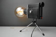 Retro lamp from an old camera with an Edison lamp on a gray background. Concept is a good idea.
