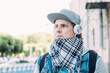© gesrey - Caucasian man in headphones listens to music and walks around the city