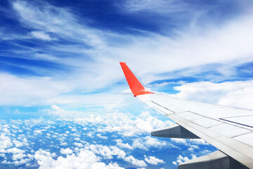 beautiful landscape view background of sky above cloud  plane's window and see plane's wing