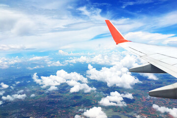 beautiful landscape view background of sky above cloud  plane's window and see plane's wing