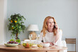 © Seventyfour - Portrait of elegant mature woman speaking by smartphone while enjoying dinner at home or cafe, copy space