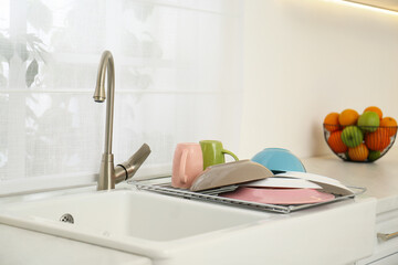 Canvas Print - Drying rack with clean dishes over sink in kitchen