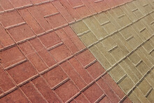 Background: Paving Slabs Of Red And Yellow Rectangles Close-up.