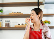 © ake - young attractive Asian woman recording cooking lesson online live streaming vlogger in the kitchen. Work from home concept. social media influencer concept.