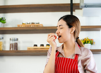 young attractive Asian woman recording cooking lesson online live streaming vlogger in the kitchen. Work from home concept. social media influencer concept.