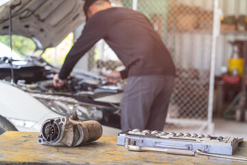 Wall Mural - Starter motor of the car on working table in repair and maintenance garage