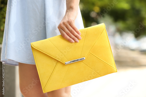 Young woman with elegant envelope bag outdoors on summer day, closeup Tableau sur Toile