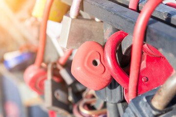 Wall Mural -  locks of hearts of different colors and shapes hanging in rows on top of each other on a metal fence as a sign of eternal love, which were closed during a wedding on the embankment.