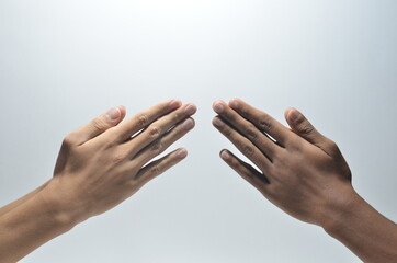 Wall Mural - Folded Praying Hands of two person in white background