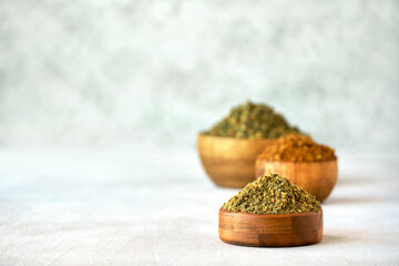 Wall Mural - Mixed spice zaatar or zatar in wooden bowls, Various type of zaatar blend. Close up with copy space