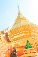 Wall Mural - Beautiful northern Thai style architectural of golden pagoda and golden Buddha Image at Wat Phra That Doi Suthep, the famous temple and became the landmark of Chiang Mai, Thailand.