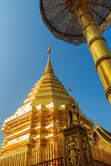 Wall Mural - Beautiful northern Thai style architectural of golden pagoda with golden umbrella at Wat Phra That Doi Suthep, the famous temple and became the landmark of Chiang Mai, Thailand.