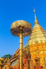 Wall Mural - Beautiful northern Thai style architectural of golden pagoda with golden umbrella at Wat Phra That Doi Suthep, the famous temple and became the landmark of Chiang Mai, Thailand.