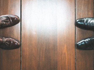 two vintage formal dress shoe on wooden floor with copy space provided. Social distance concept. male shoes.