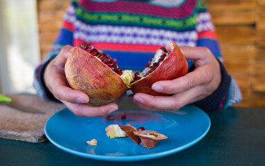 Ripe juicy pomegranate divided into two halves.