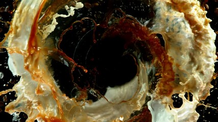 Fototapete - Super slow motion of rotating coffee beans with splashes on black background. Filmed on high speed cinema camera, 1000 fps.