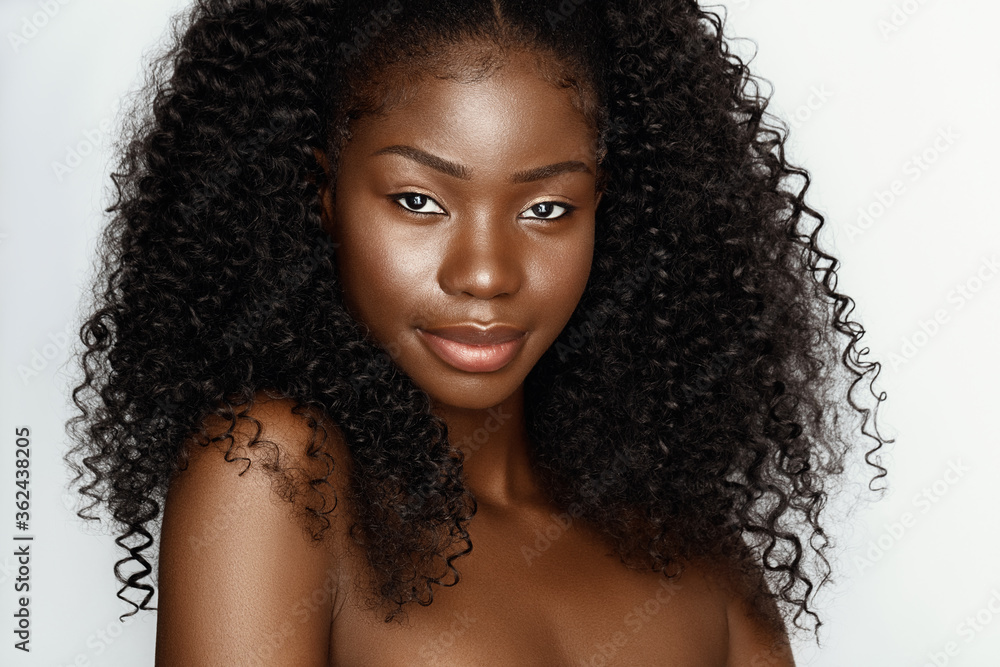 Fashion portrait of young beautiful african american woman with curly hair againstgray background - obrazy, fototapety, plakaty 