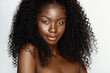 © Beauty Agent Studio - Fashion portrait of young beautiful african american woman with curly hair againstgray background