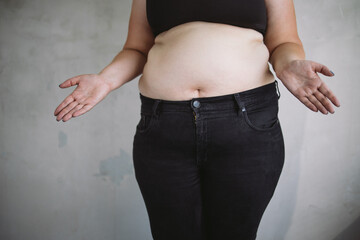 Wall Mural - Overweight bewildered woman throwing up hands. Dieting, weight loss and health care concept. Copy space