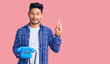 © Krakenimages.com - Handsome latin american young man holding vintage telephone surprised with an idea or question pointing finger with happy face, number one