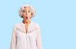 Senior grey-haired woman wearing casual clothes afraid and shocked with surprise expression, fear and excited face.