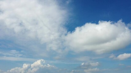 Wall Mural - Beautiful blue sky with clouds background. Sky clouds. Sky with clouds weather nature cloud blue. Blue sky with clouds and sun. Loop.