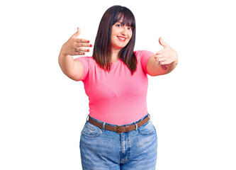 Poster - Young plus size woman wearing casual clothes looking at the camera smiling with open arms for hug. cheerful expression embracing happiness.