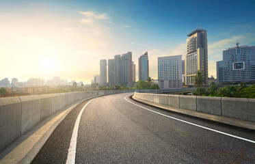 Highway overpass motion blur effect with modern city background.