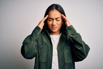 Poster - Young beautiful asian woman wearing casual shirt standing over isolated white background with hand on head for pain in head because stress. Suffering migraine.