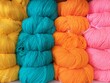 Stack of colorful knitting wool, Knitting is a method by which yarn is manipulated to create a textile or fabric, often used in many types of garments