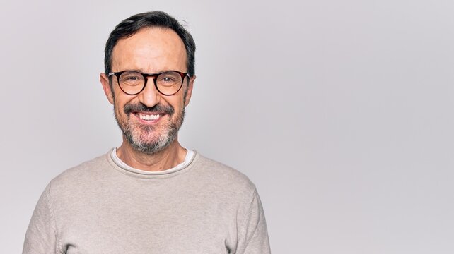middle age handsome man wearing casual sweater and glasses over isolated white background with a hap