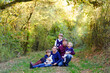 © Irina Schmidt - Portrait of young parents with three children. Mother, father, two kids brothers boys and little cute toddler sister girl having fun together in autumn forest. Happy family of five
