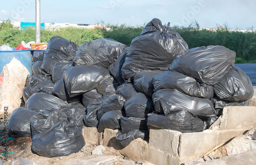 pollution and Garbage Disposal and pile of black bags garbage prepare waste disposal, bangkok, thailand