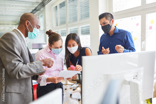 Business people with mask during project development