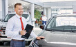 © alfa27 - portrait of smiling car dealer at work, man in white formal shirt ready to talk about cars, automobiles and their chaacteristics to customers