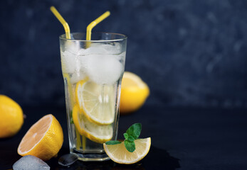 Summer refreshing cold lemonade Mojito on a dark table with copy space