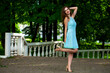 Full body portrait of a young beautiful model in turquoise dress