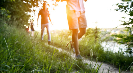 Blurred view of  friends are walking through the pathway on the hill