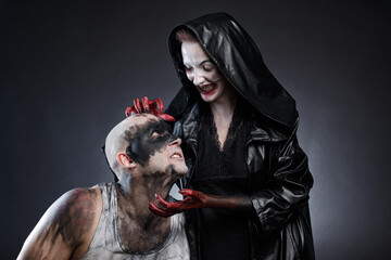 Mad man and scary woman with blood hands