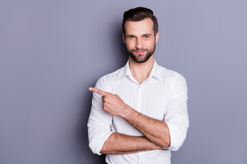 Portrait of positive cheerful man investor attorney chief point index finger copyspace recommend excellent ads promotion wear white shirt isolated over gray color background