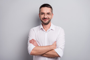 Close-up portrait of his he nice attractive cheery content mature man skilled qualified banker financier specialist wearing specs folded arms isolated over light gray pastel color background