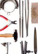 © DadoPhotos - Different goldsmiths tools on the jewelry workplace. Desktop for craft jewelry making with professional tools. White background.
