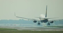
The Plane Lands At The Airport. Purchase Plan Of The Plane Landing On The Runway, You Can See How Smoke Appears From Under The Wheels Of The Plane.