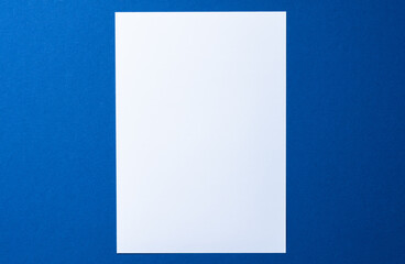 Poster - Blank paper business mock up on classic blue background