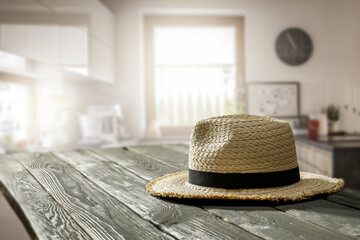 Wall Mural - Hat on the table in the summer kitchen on a sunny morning