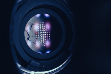 Poster - Close up Beautiful Camera Lens on a dark with red reflection light background. Macro view.
