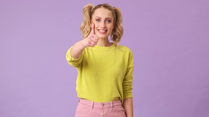 Poster - a charming girl smiles and shows ok to the camera in an isolated studio on a purple background